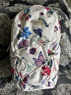 north face backpack white floral The Jester Luxe for Women in Gardenia White/Burnt Coral Metallic allowing you to conquer any trail with ease The North Face - Women's